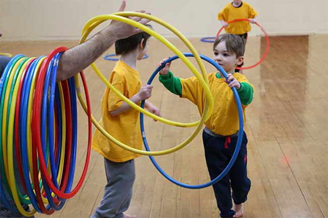 Children playing with cereals in karate class.